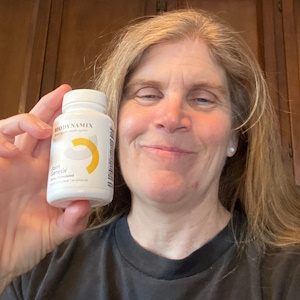 Customer Ann J. holding a bottle of Joint Genesis